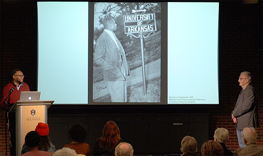 Aaron R. Turner (left), and Robert Cochran (right) looking at a signed photograph of Silas Hunt taken in 1948 by Geleve Grice; Geleve Grice image courtesy of Geleve Grice Papers | Special Collections | University of Arkansas © Pryor Center for Arkansas Oral and Visual History, University of Arkansas