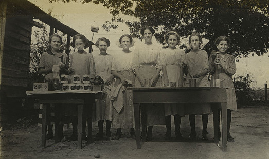 "Tomato" Girls Club group displaying fresh and canned tomatoes, 1912; Mabelvale Home Demonstration Club Records MC1640 © Pryor Center for Arkansas Oral and Visual History, University of Arkansas