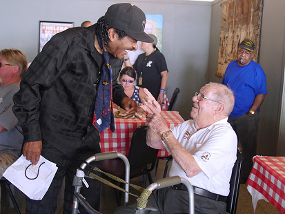 Bobby Rush (left) talks to Sonny Payne at the Bobby Rush Appreciation Day event, which was held at Southbound Pizza during the King Biscuit Blues Festival; Helena, Arkansas, 2016 © Pryor Center for Arkansas Oral and Visual History, University of Arkansas