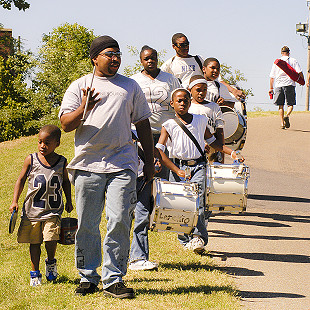 A drum corps marchs into tent city during the Arkansas Blues and Heritage Festival; 2006 © Eric Gorder 2006; egorder@gmail.com