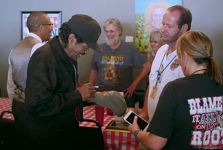 Bobby Rush signs autographs at the Bobby Rush Appreciation Day event, which was held at Southbound Pizza during the King Biscuit Blues Festival; Helena, Arkansas, 2016 © Pryor Center for Arkansas Oral and Visual History, University of Arkansas